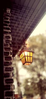 Low angle view of illuminated lamp at sunset