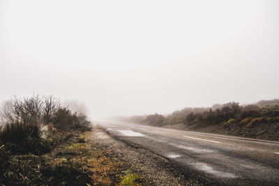 Surface level of road against clear sky