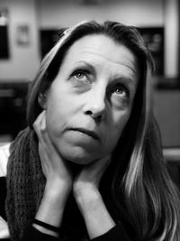Close-up portrait of young woman at home