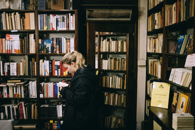 Rear view of woman reading book