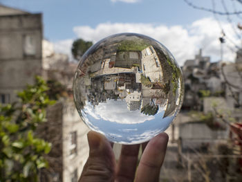 Close-up of hand holding glass of crystal ball