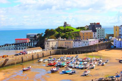 High angle view of buildings by sea against sky