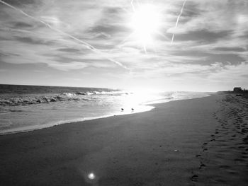 Scenic view of beach against sky during sunset