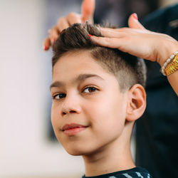 Hair styling boy's hair in hair salon