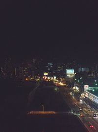 Illuminated cityscape against sky at night