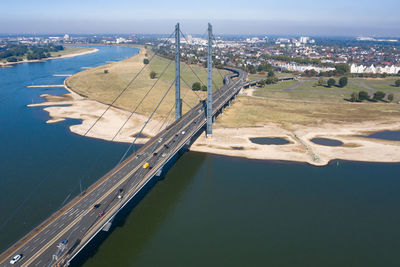 High angle view of bridge over river in city against sky