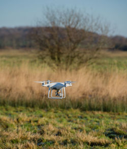 Close-up of camera on field against sky