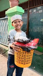 Portrait of smiling boy holding basket