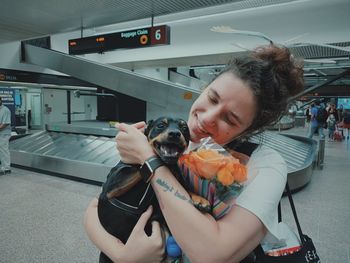 Midsection of woman holding dog