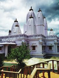 Low angle view of building against cloudy sky