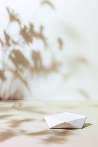 Scene with polygonal podium on beige background and shadows