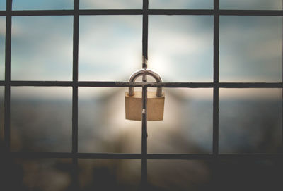 Close-up of padlocks on metal grate