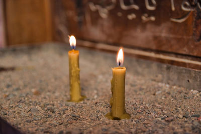 Close-up of lit candles in temple