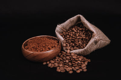 High angle view of bread in container on table against black background