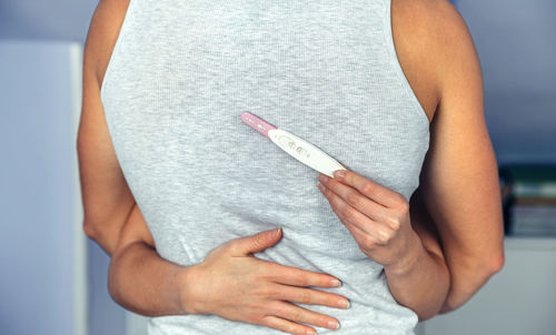 Midsection of woman holding cigarette