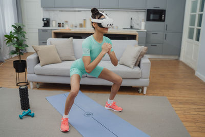 Full length of woman exercising in gym