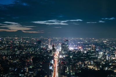 High angle view of city lit up at night