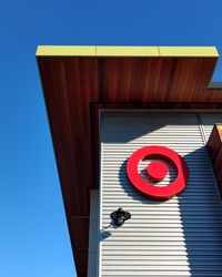 Low angle view of sign on building against clear sky