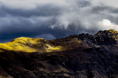 Scenic view of snowcapped mountains against cloudy sky