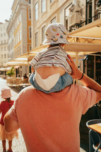 Rear view of woman standing in city