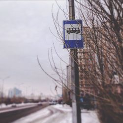 Road sign against sky