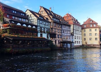 Bridge over river against buildings in city