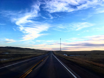 Road passing through landscape against sky