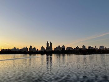 Buildings in city at sunset