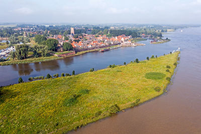 Aerial from the city woudrichem at the river merwede in the netherlands in a flooded landscape