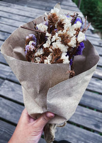 Close-up of hand holding flower bouquet