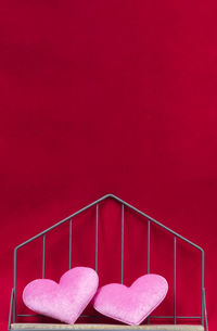 Close-up of heart shape on pink railing