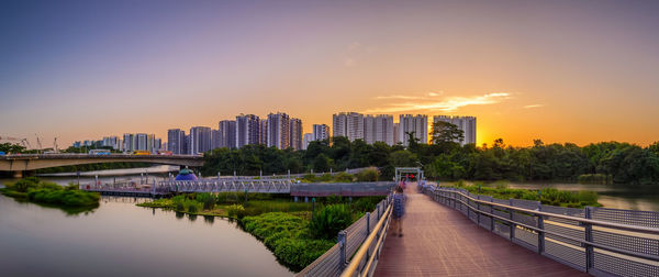 Panoramic view of buildings in city against sky during sunset