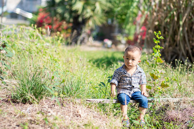 Full length of a boy sitting on grass