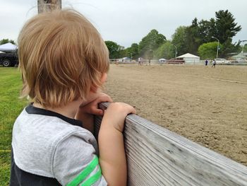 Rear view of girl relaxing in park