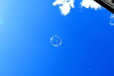 Low angle view of moon against blue sky