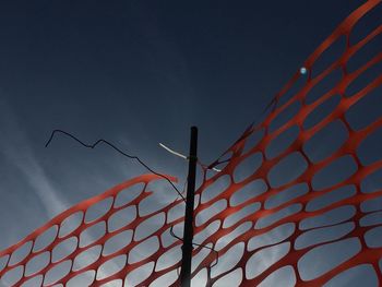 Construction orange mesh against the sky