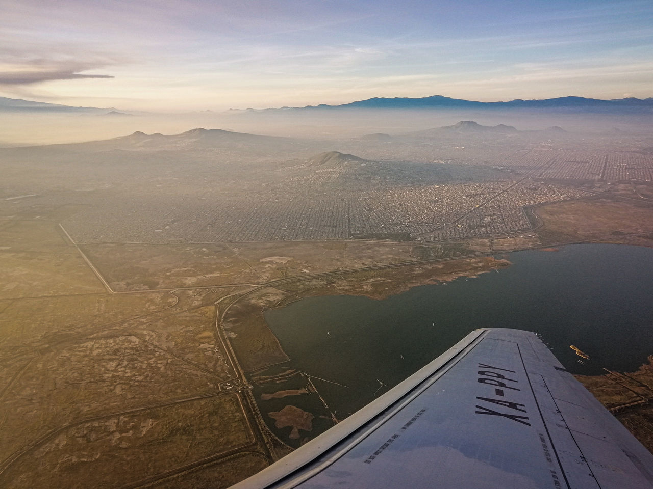 AERIAL VIEW OF LANDSCAPE AND AIRPLANE AGAINST SKY