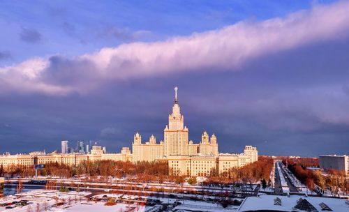 Heavy dramatic storm clound over winter campus of moscow university illuminated with sunset light