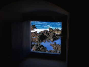 Scenic view of sea seen through window
