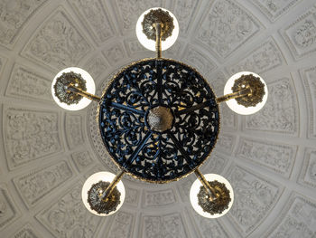 Low angle view of chandelier hanging on ceiling in building