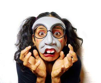 Portrait of woman wearing mask against white background