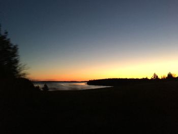 Scenic view of sea against clear sky during sunset