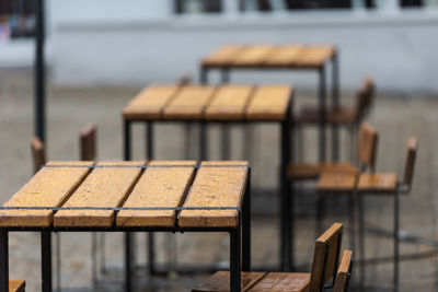 Close-up of empty chairs and table in cafe