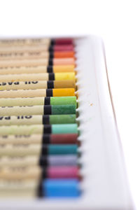 Close-up of colored pencils on white table