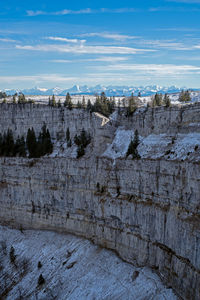 Scenic view of rocky canyon against mountains and sky