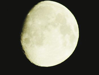 Low angle view of moon in dark sky