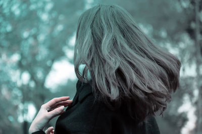 Rear view of woman against trees