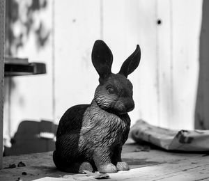 Close-up of artificial rabbit on table in back yard