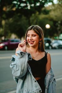 Young woman smiling while standing in city