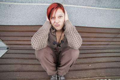 Portrait of smiling young woman sitting outdoors